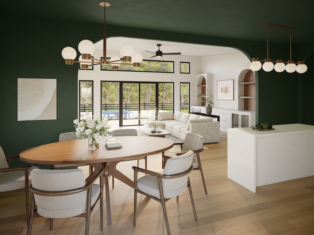 Forest-green kitchen with arched openings and a round oak table