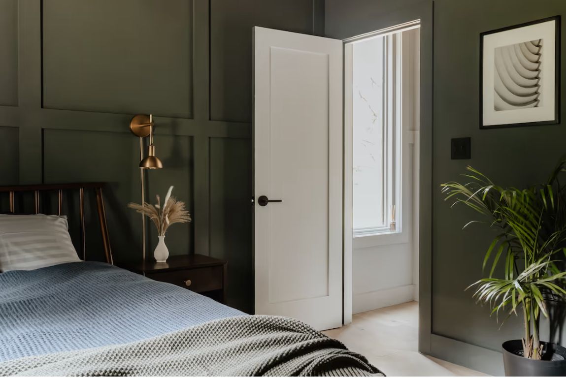 Green bedroom with paneled walls